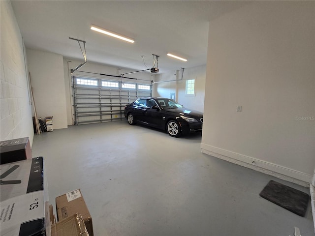 garage featuring a garage door opener and concrete block wall