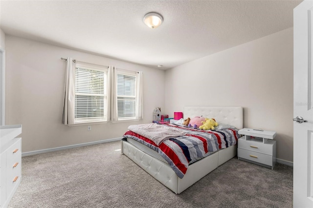 carpeted bedroom featuring a textured ceiling