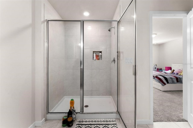 bathroom featuring tile patterned flooring and a shower with shower door