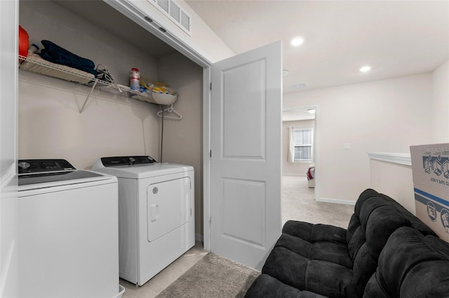 washroom with washing machine and dryer and light colored carpet