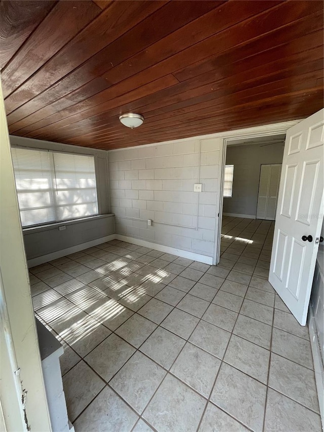 unfurnished room featuring light tile patterned floors and wooden ceiling