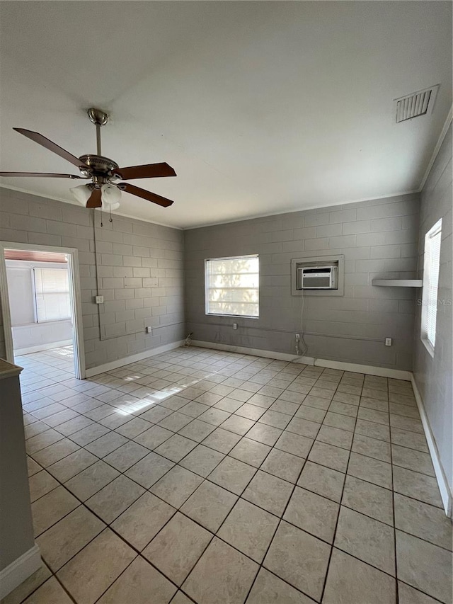 empty room with light tile patterned floors and ceiling fan