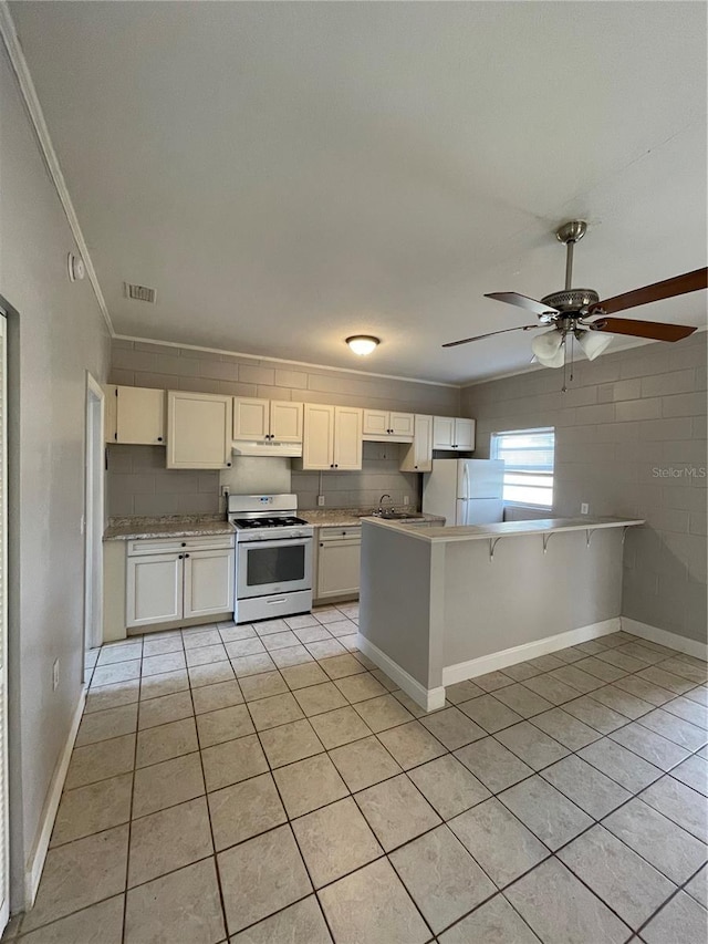 kitchen featuring white cabinetry, white appliances, kitchen peninsula, and light tile patterned floors