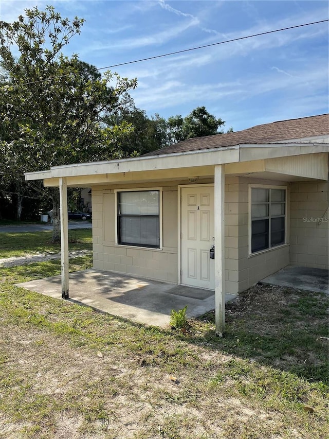 view of property exterior featuring a yard and a patio area