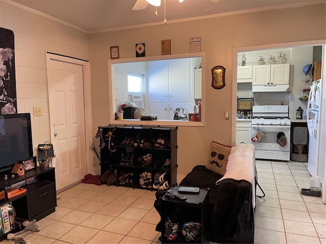 tiled living room with crown molding and ceiling fan