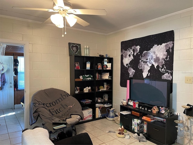 sitting room with tile patterned flooring, crown molding, and ceiling fan