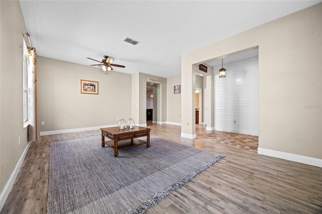 unfurnished living room with hardwood / wood-style flooring and ceiling fan