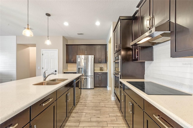 kitchen with tasteful backsplash, sink, hanging light fixtures, stainless steel appliances, and dark brown cabinets