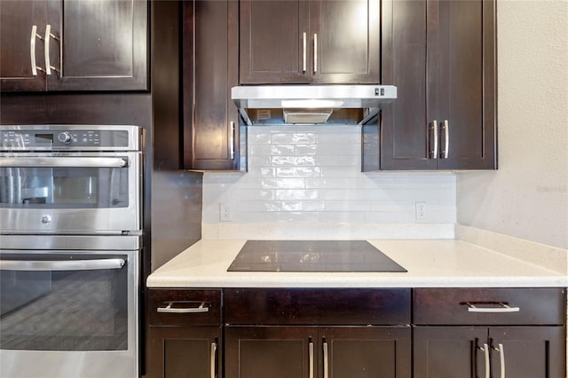 kitchen with black electric cooktop, dark brown cabinets, backsplash, and double oven