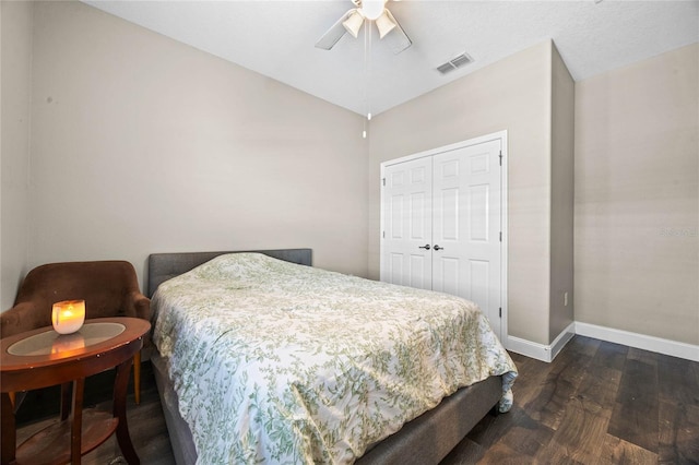 bedroom featuring a closet, vaulted ceiling, dark hardwood / wood-style floors, and ceiling fan