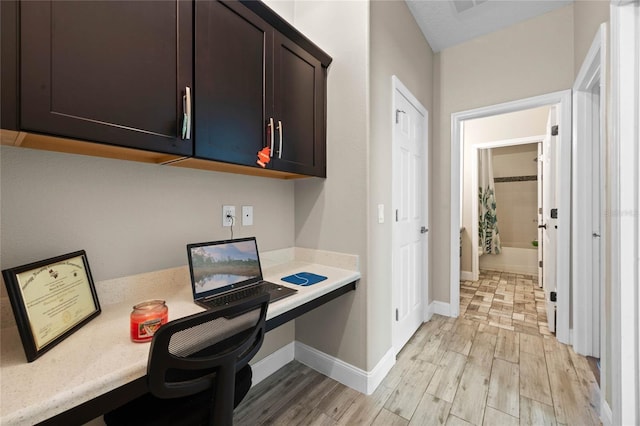 office area with built in desk and light wood-type flooring