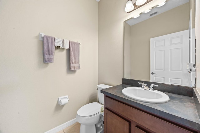 bathroom featuring vanity, tile patterned floors, and toilet