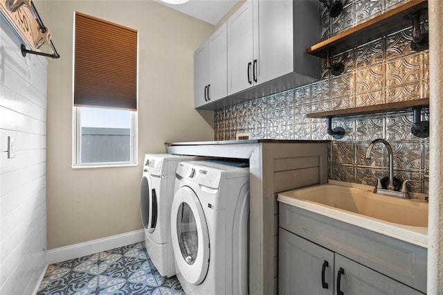 washroom with light tile patterned flooring, cabinets, separate washer and dryer, and sink