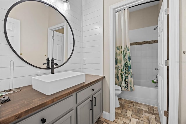 full bathroom featuring vanity, toilet, and shower / bath combo with shower curtain