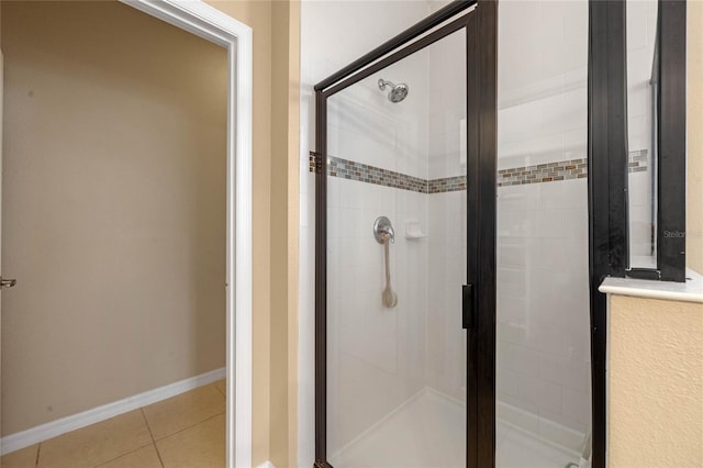 bathroom with an enclosed shower and tile patterned floors