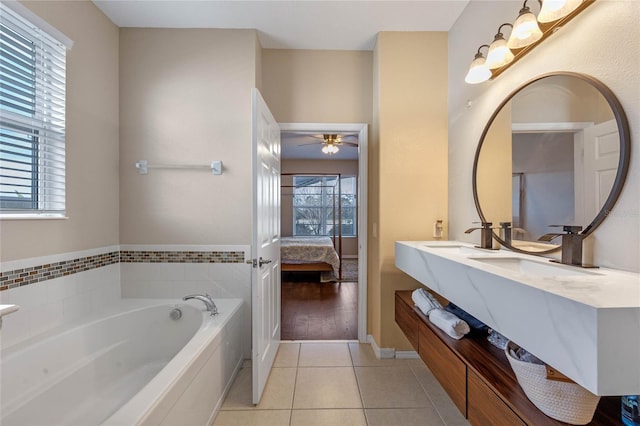 bathroom with tile patterned flooring, vanity, a washtub, and ceiling fan