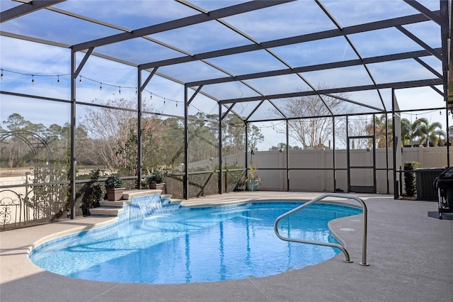 view of swimming pool featuring pool water feature, a lanai, and a patio area