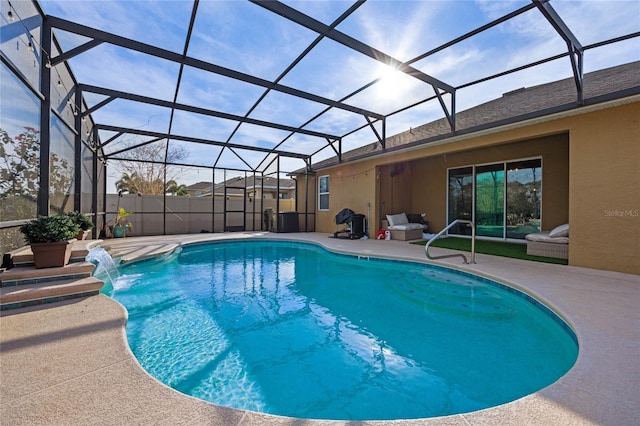 view of swimming pool with a patio, pool water feature, and a lanai