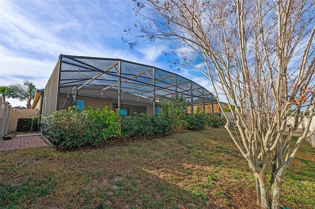 view of yard featuring glass enclosure