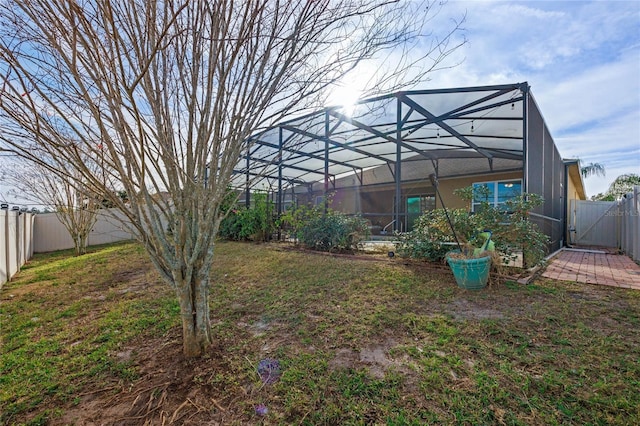 view of yard with glass enclosure