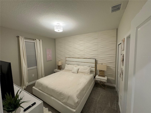 carpeted bedroom with a textured ceiling