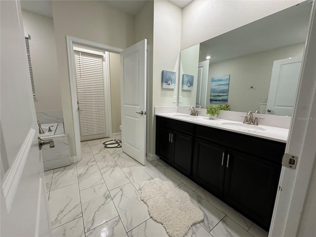 bathroom with vanity and a tub