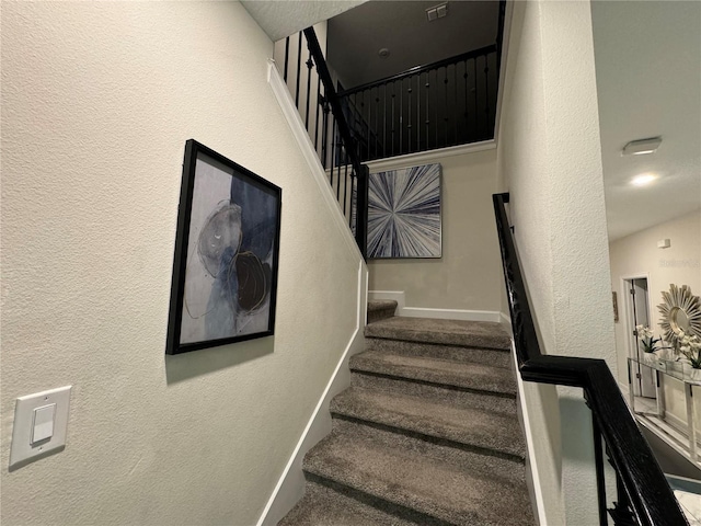 stairs featuring carpet floors