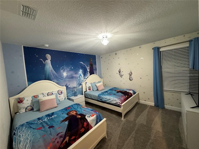 bedroom with a textured ceiling and dark colored carpet