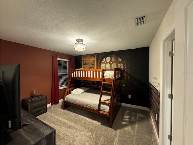 bedroom with carpet floors and a textured ceiling