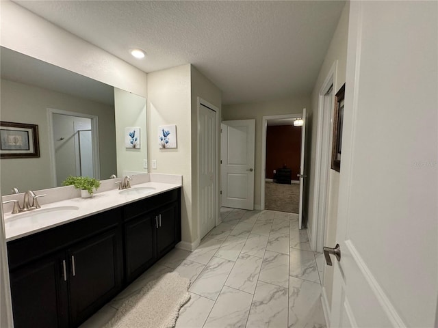 bathroom featuring vanity and a textured ceiling