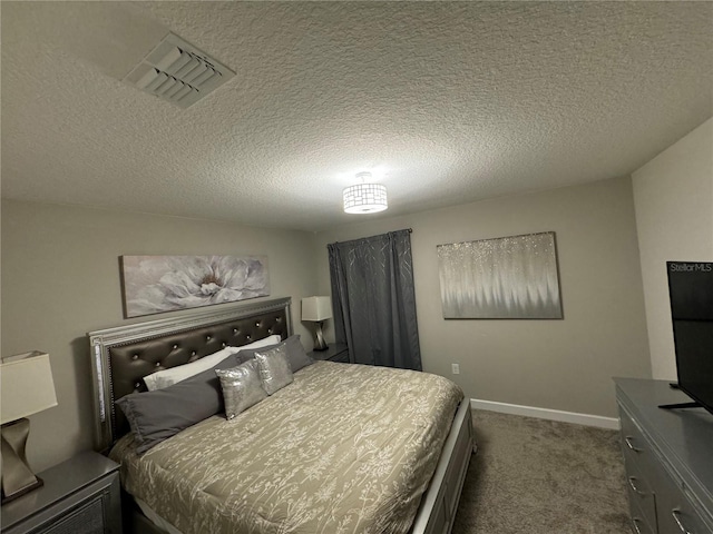 carpeted bedroom featuring a textured ceiling