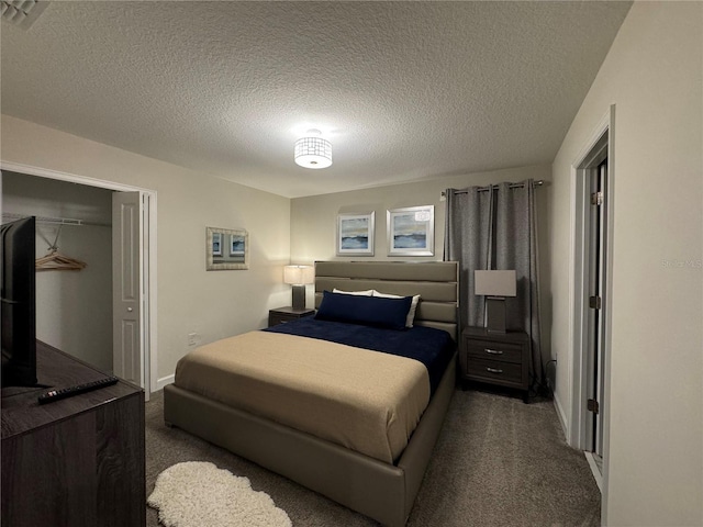 bedroom featuring dark carpet, a closet, and a textured ceiling