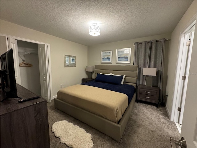 carpeted bedroom featuring a textured ceiling and a closet