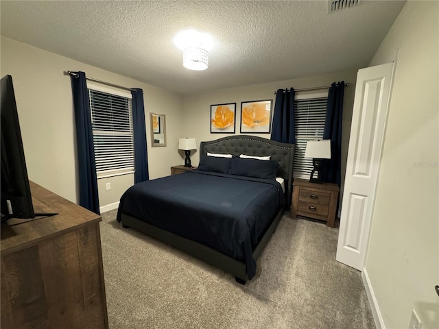 carpeted bedroom with a textured ceiling