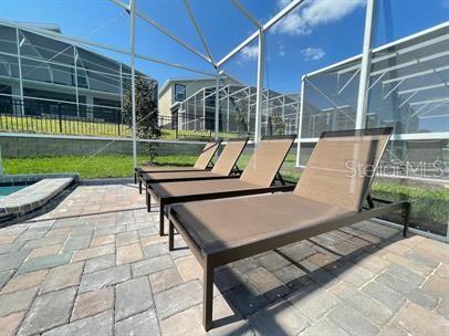 view of patio featuring a lanai