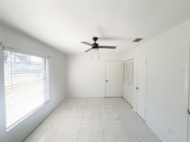 spare room with ceiling fan