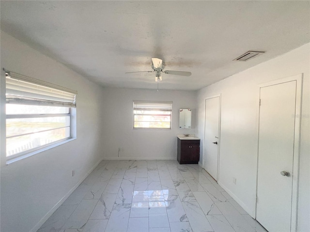 unfurnished bedroom featuring sink and ceiling fan