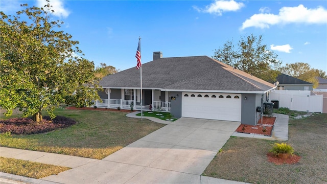 single story home featuring a garage, a front lawn, and covered porch