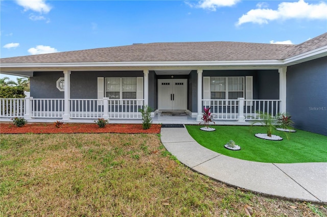 single story home featuring a front yard and covered porch