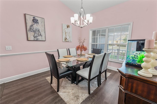 dining area featuring dark hardwood / wood-style flooring, vaulted ceiling, and a notable chandelier