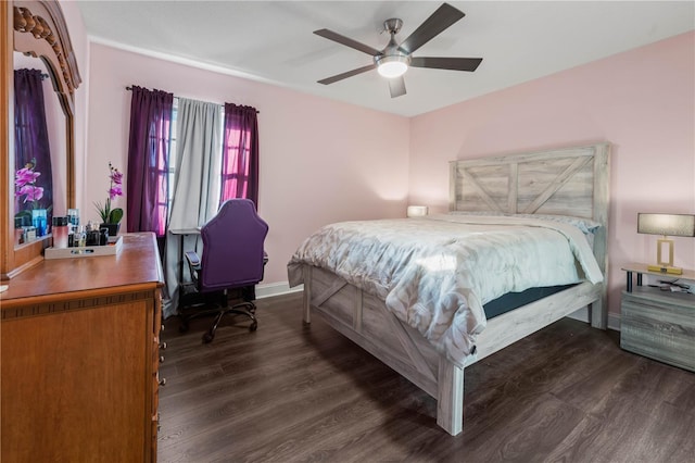 bedroom with dark hardwood / wood-style flooring and ceiling fan