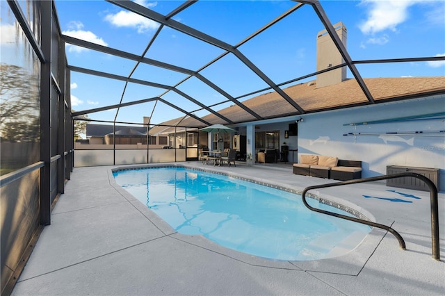 view of pool with a lanai, outdoor lounge area, and a patio area