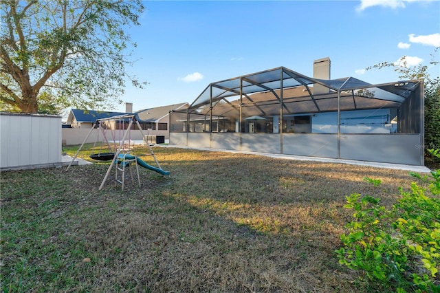 view of yard featuring a lanai and a playground