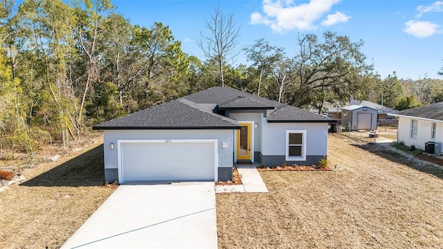 view of front of home with a garage and central AC unit