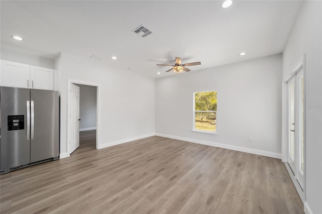 unfurnished living room with ceiling fan and light wood-type flooring