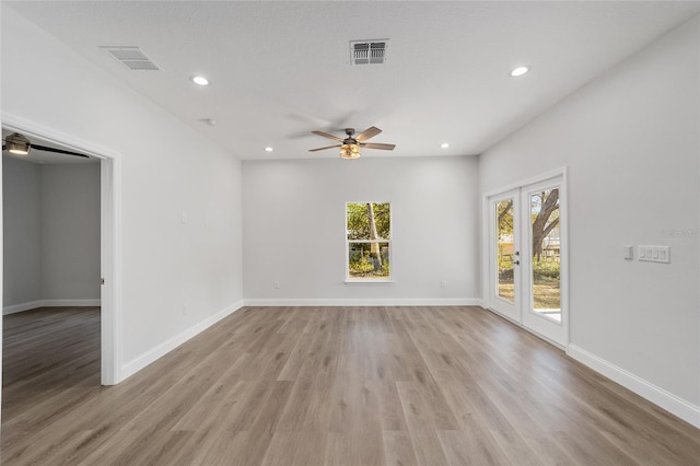 empty room with ceiling fan and light wood-type flooring