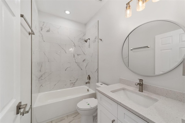 full bathroom featuring vanity, toilet, and tiled shower / bath