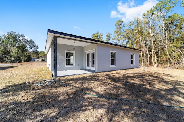 back of house with a patio and french doors