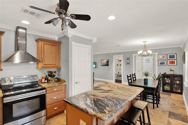 kitchen featuring wall chimney exhaust hood, stainless steel range with electric cooktop, crown molding, stone countertops, and a kitchen island