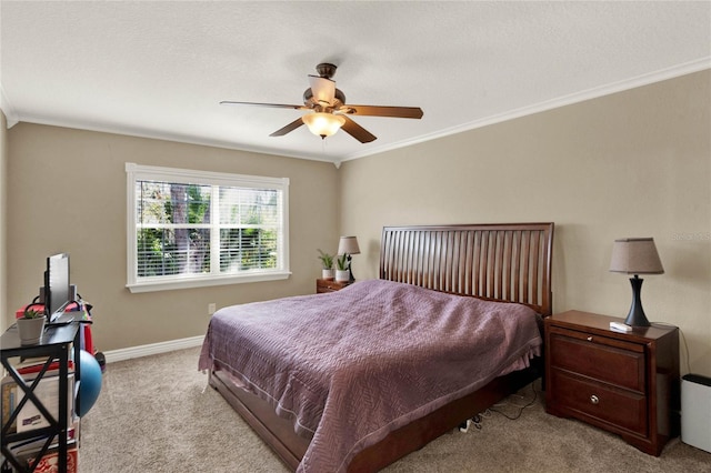 carpeted bedroom featuring ceiling fan, ornamental molding, and a textured ceiling